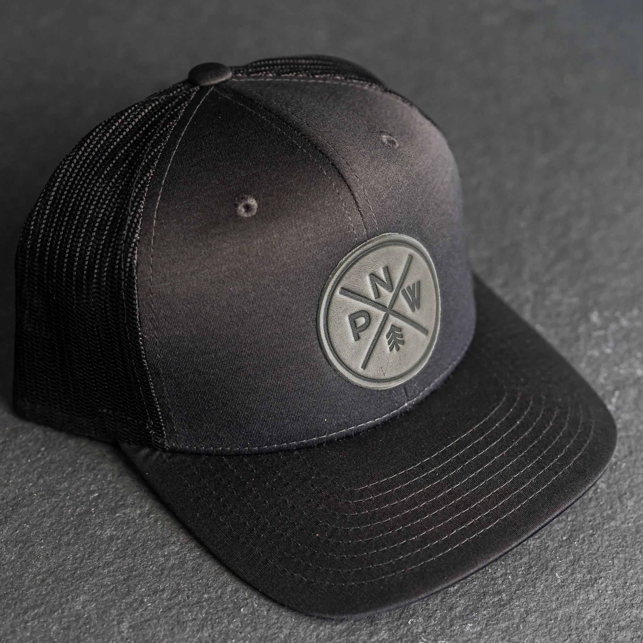 Leather Patch Performance Style Trucker Hat - PNW Stamp